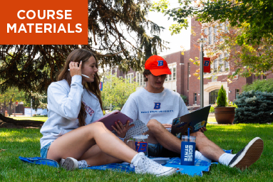 Two people reading a college textbook outside